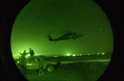 Nightscope shot as a US Army (USA) UH-60 Black Hawk helicopter comes in for a landing.