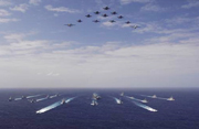 U.S. Navy aircraft from Carrier Air Wing Five fly over a formation of U.S. and Japanese ships in the Pacific Ocean Nov. 14, 2006